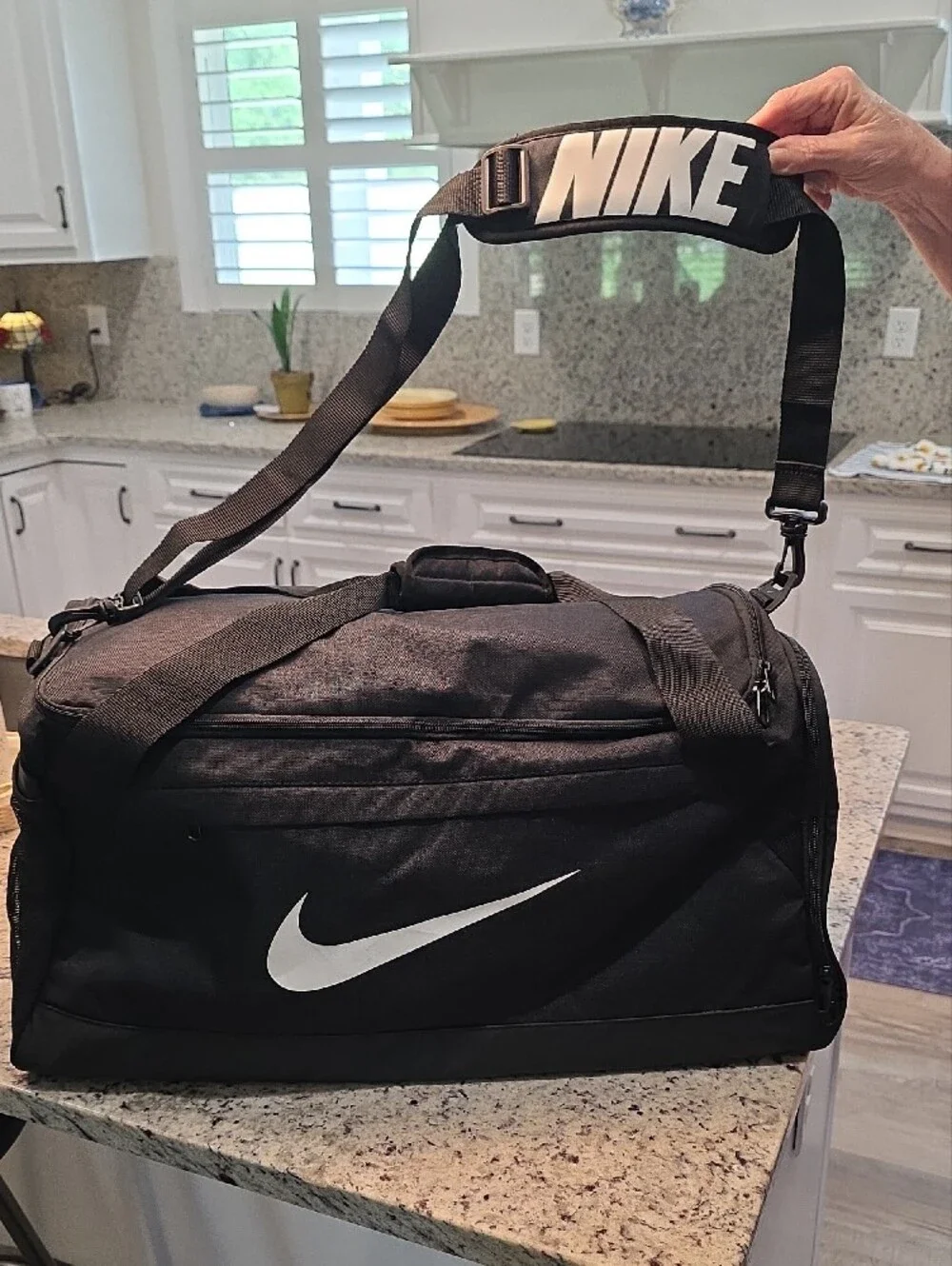 Nike Black Duffel Bag with White Swoosh and Branded Strap